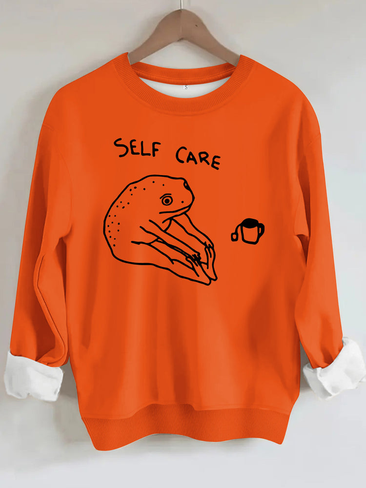 Békamintás női pulóver „Self Care” felirattal